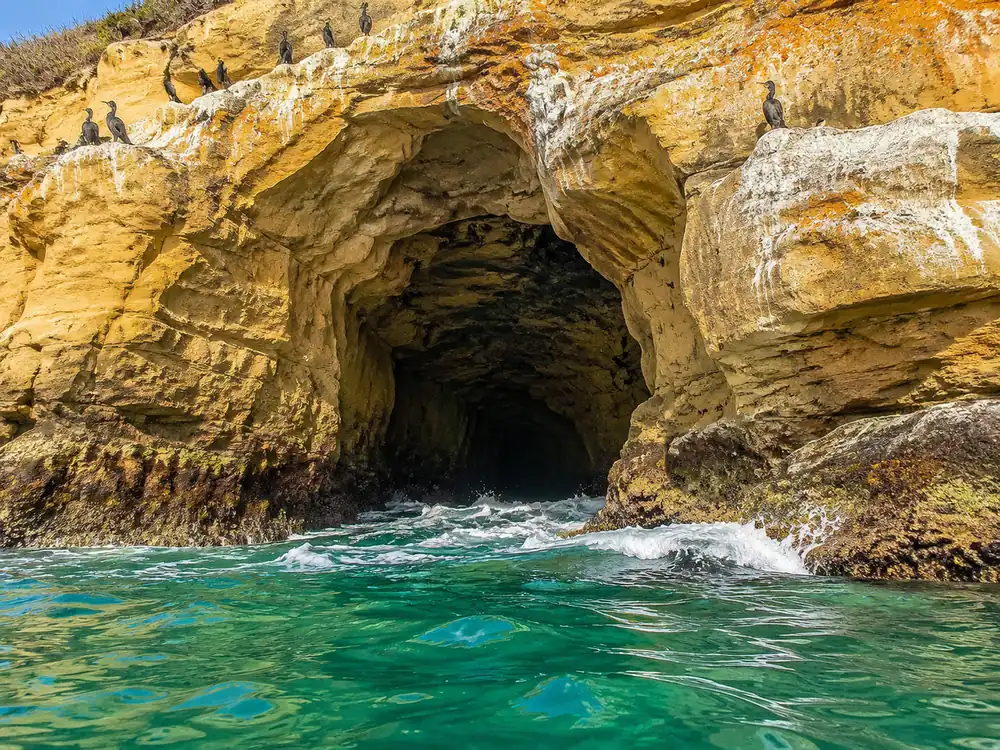 The sandstone cave mouth at water level